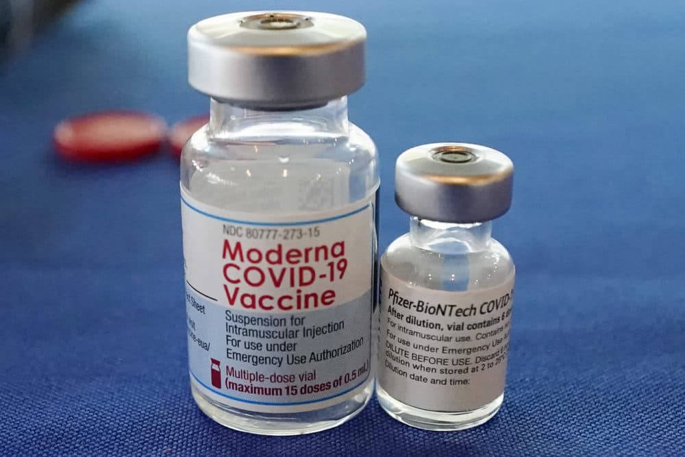 Vials of the Pfizer and Moderna COVID-19 vaccines. (Rogelio V. Solis/AP)
