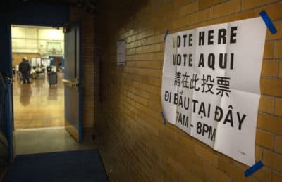 A vote here sign at the Higginson-Lewis K-8 school in Boston. (Robin Lubbock/WBUR)