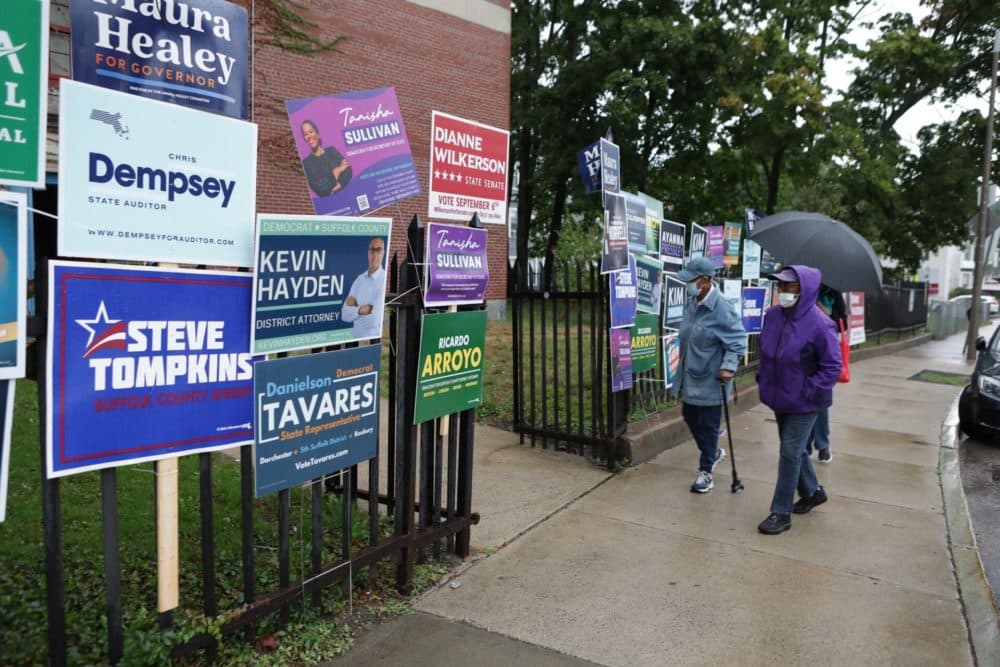 Voters walk through the rain to the Higginson-Lewis K-8 school in Boston as voting gets under way. (Robin Lubbock/WBUR).