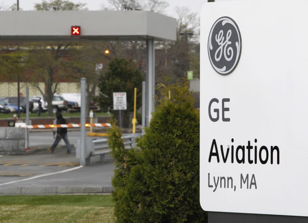 The General Electric logo is seen on a sign at the entrance to the aviation manufacturing plant in Lynn, Mass. (Steven Senne/AP file)