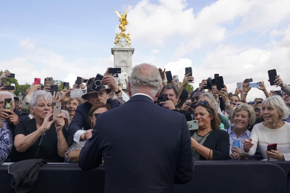 Britain's King Charles III, back to camera, greets well-wishers as he walks by the gates of Buckingham Palace following Thursday's death of Queen Elizabeth II, in London, Friday, Sept. 9. (Yui Mok/AP)