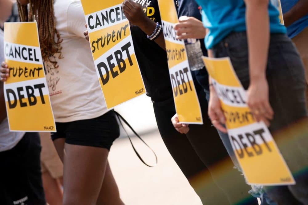 Activists hold cancel student debt signs as they gather to rally in front of the White House in Washington, DC, on Aug. 25, 2022. (Stefani Reynolds/AFP via Getty Images)