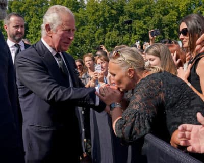 LONDON: A well-wisher kisses the hand of King Charles III during a walkabout outside Buckingham Palace to view messages and tributes following the death of Queen Elizabeth II. (Yui Mok - WPA Pool/Getty Images)