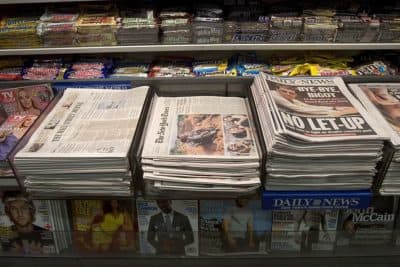 The New York Times and other newspapers are displayed at a newsstand in the Times Square subway station in New York City. (Michael Brown/Getty Images)