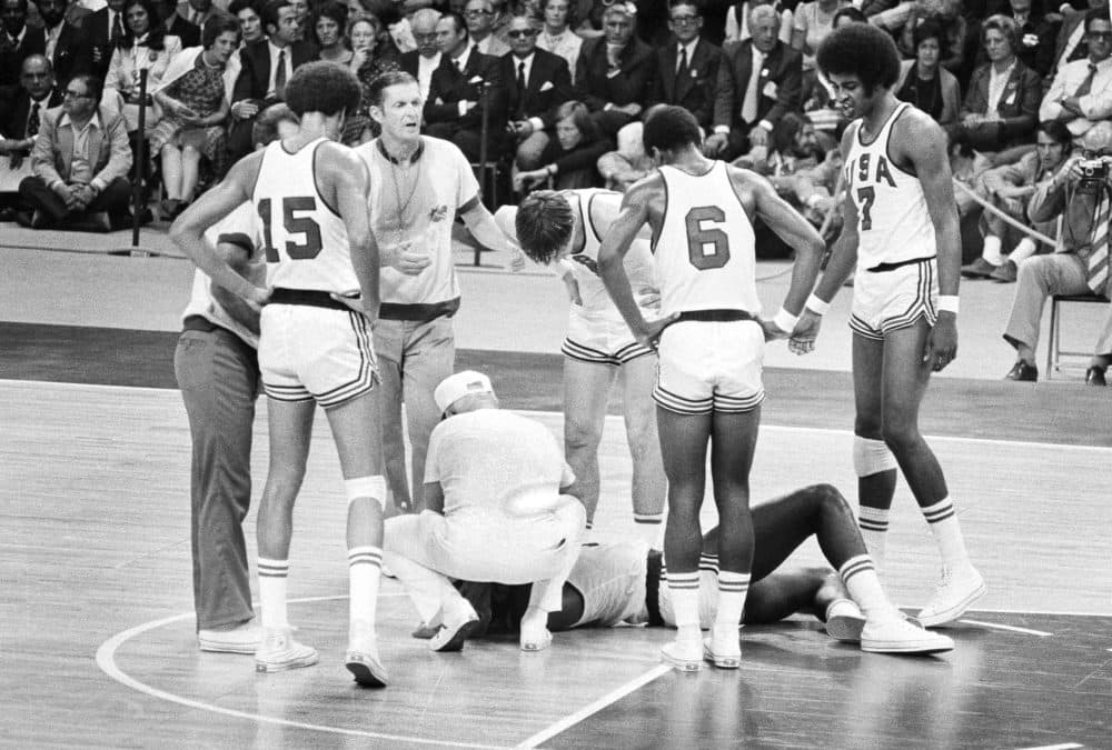 U.S. player James Brewer is checked after a hard fall during the team's men's basketball final against the Soviet Union at the Olympics in Munich, Sept. 10, 1972. (AP)