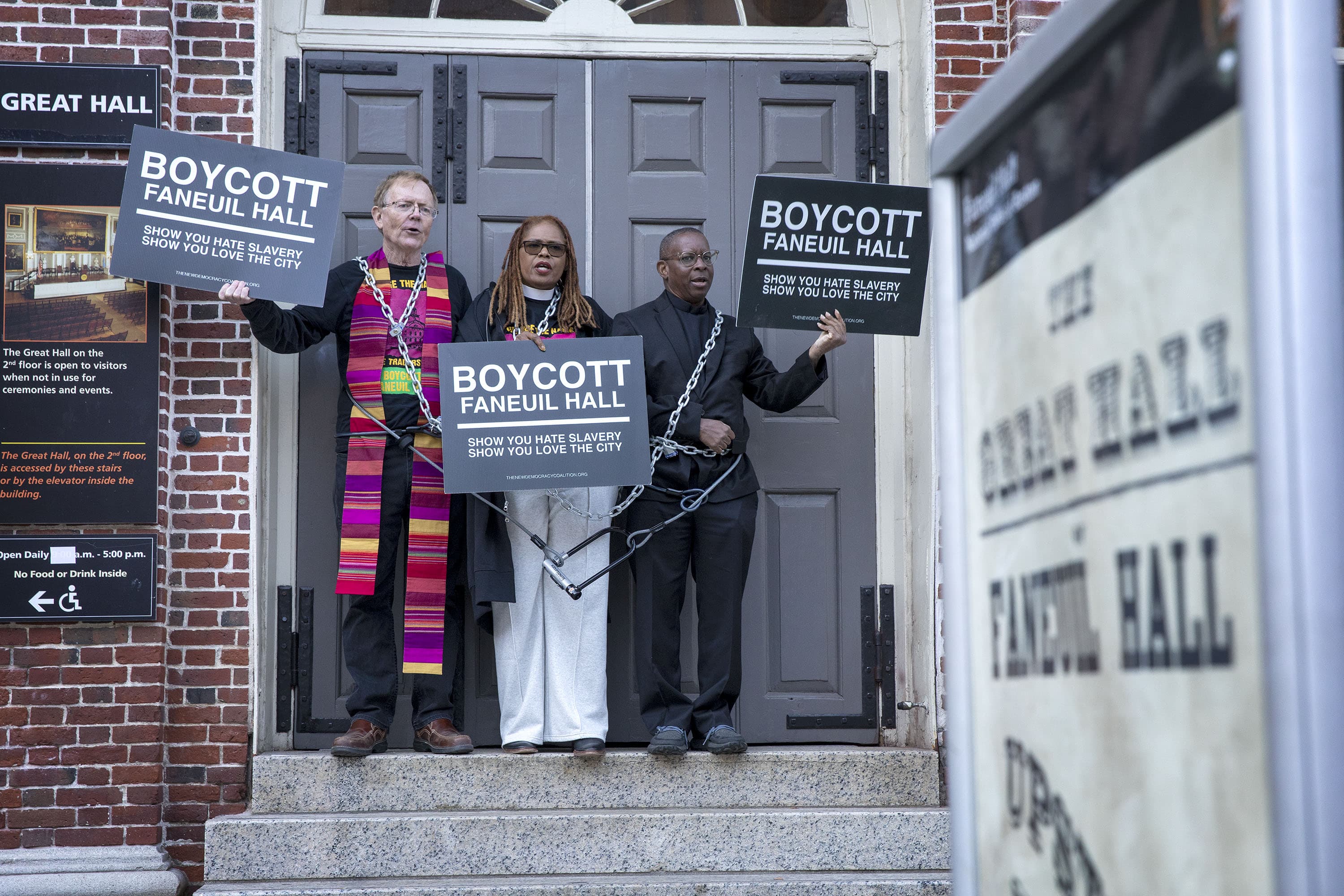 Left to right: Rev. John Gibbons, Pastor Valerie Copeland and Rev. Dr. Kevin Peterson call for a boycott of Faneuil Hall at a protest demanding the name of the hall should be changed. (Robin Lubbock/WBUR)