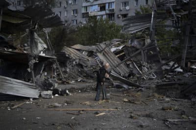 An elderly man walks past a car shop that was destroyed after a Russian attack in Zaporizhzhia, Ukraine. (Leo Correa/AP)