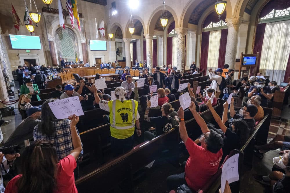 People hold signs and shout slogans as they protest before the cancellation of the Los Angeles City Council meeting Wednesday, Oct. 12, 2022, in Los Angeles. The explosive recording of Los Angeles city council members making racist and disparaging remarks have deeply hurt the city's indigenous immigrants from Mexico. (Ringo H.W. Chiu/AP)