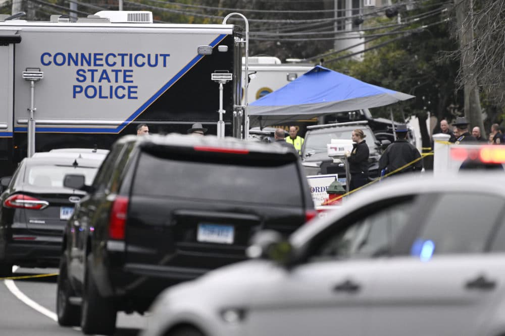 Members of the Connecticut State Police Major Crime unit on scene where two police officers killed, Thursday in Bristol, Conn. Two police officers were fatally shot and a third wounded while responding to a domestic violence call, authorities said Thursday, amid an exceptionally violent week for officers across the country. (Jessica Hill/AP)