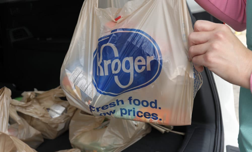 A customer removes her purchases at a Kroger grocery store. (Rogelio V. Solis/AP)