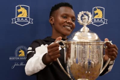 Diana Kipyokei, of Kenya, holds a Boston Marathon championship trophy following a news conference, on Oct. 12, 2021. (Steven Senne/AP)