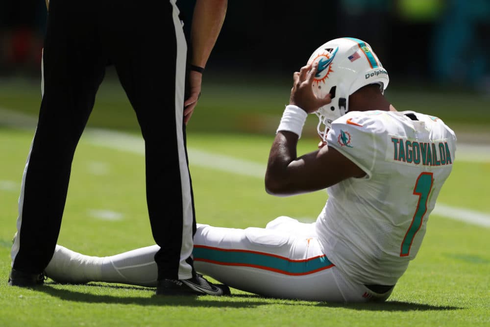 Tua Tagovailoa #1 of the Miami Dolphins sits on the turf during the first half of the game against the Buffalo Bills at Hard Rock Stadium on Sept. 25, 2022 in Miami Gardens, Florida. (Megan Briggs/Getty Images)