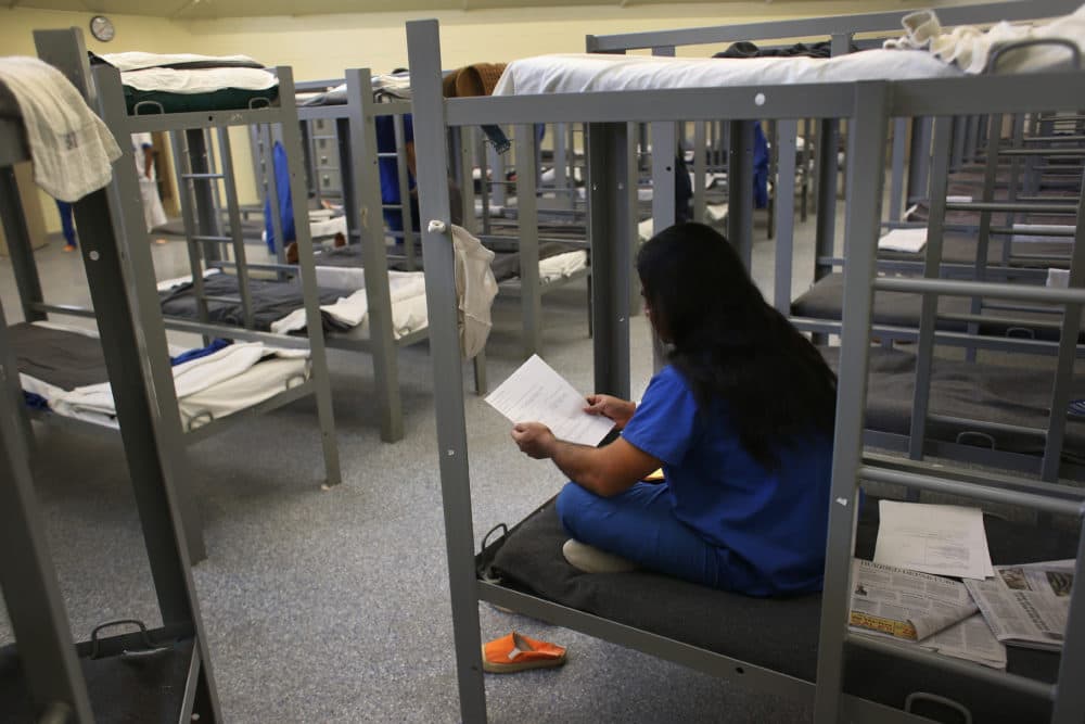 An immigration detainee from Bangladesh reads through his case papers while on his bunk at the Immigration and Customs Enforcement (ICE), detention facility on Feb. 28, 2013 in Florence, Arizona. (John Moore/Getty Images)