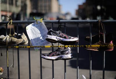Running shoes are placed at a makeshift memorial for victims of the Boston Marathon bombings near the finish line at the intersection of Newbury Street and Darthmouth Street on April 21, 2013, in Boston. (Kevork Djansezian/Getty Images)