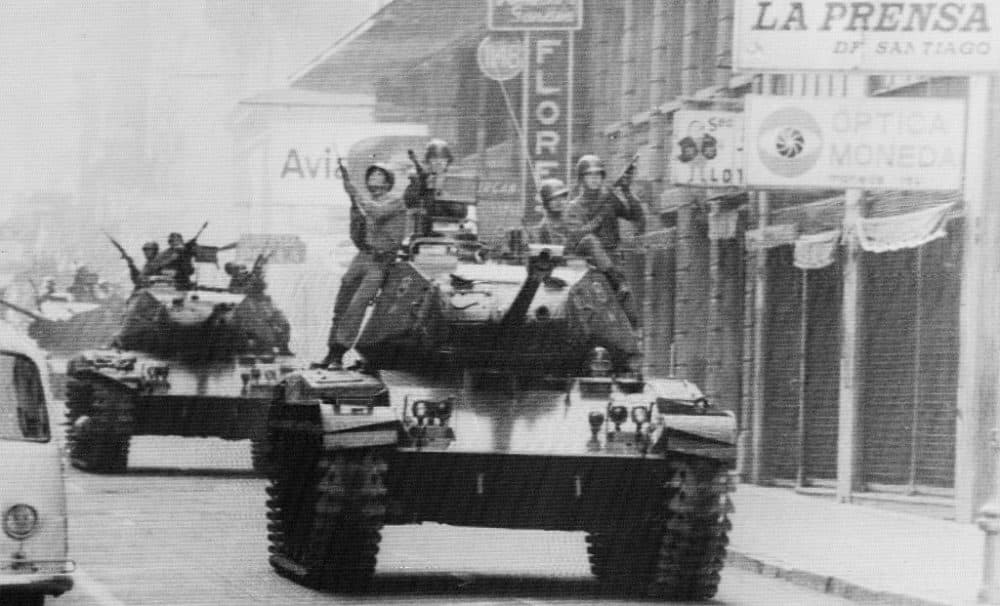 Armed soldiers ride atop tanks in the streets of Santiago here on September 12th, as Army Commander General Augusto Pinochet Pinochet is sworn in as President.  