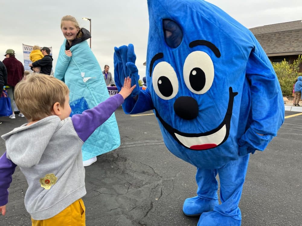 WaterSmart Wally, the mascot for Hays' water conservation program, gives a &quot;high five&quot; at a local street fair. (David Condos/KNS)
