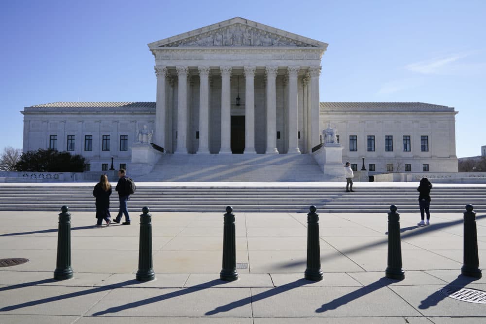 Visitors walk outside the Supreme Court building on Capitol Hill in Washington, on Feb. 21, 2022. (Patrick Semansky/AP)