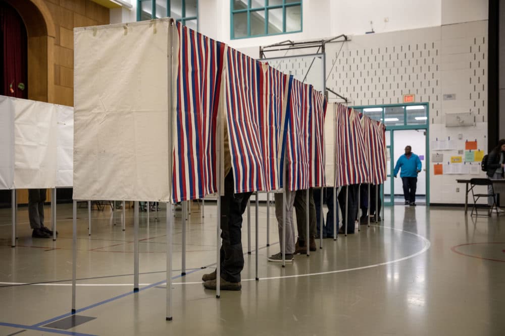 Voters inside polling stations. (Jesse Costa/WBUR)