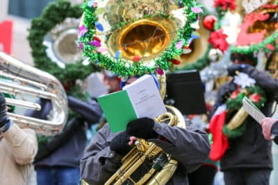 A player consults sheet music at Boston &quot;TubaChristmas&quot; rehearsal. (Courtesy George Comeau)