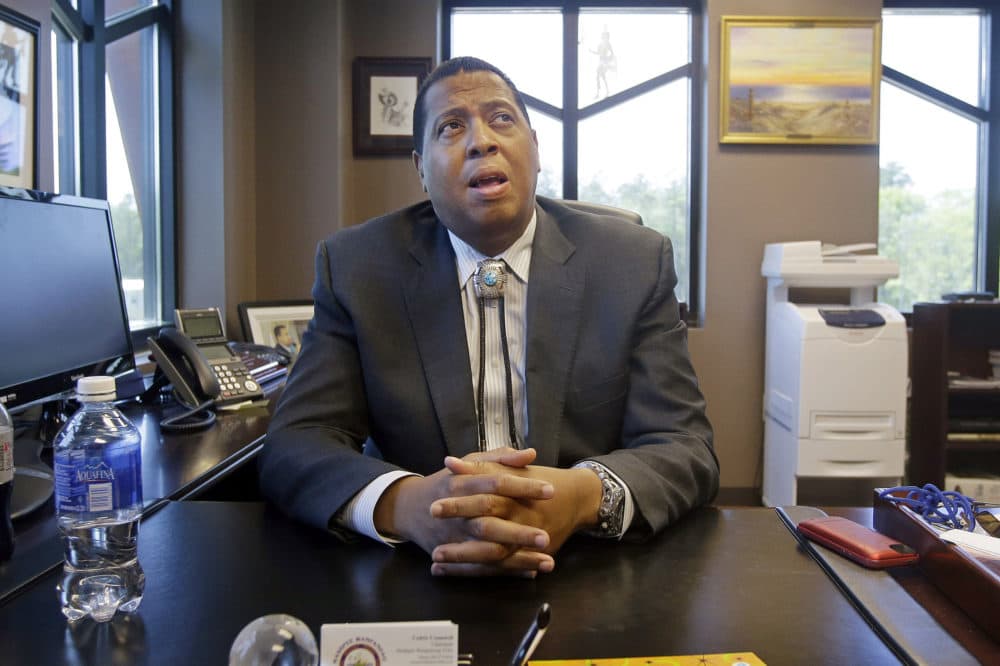 Mashpee Wampanoag Tribe Chairman Cedric Cromwell sits behind his desk at the government center in Mashpee, Mass., May 29, 2014.(Stephan Savoia/AP File)