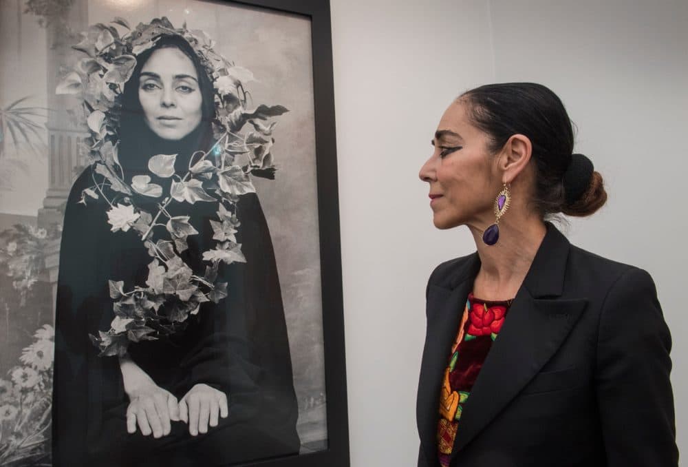 Iranian visual artist Shirin Neshat stands next to an untitled work from her &quot;Women of Allah&quot; series, during the Frieze Los Angeles 2020 art fair in Los Angeles, California, on Feb. 14, 2020. (MARK Ralston/AFP via Getty Images)