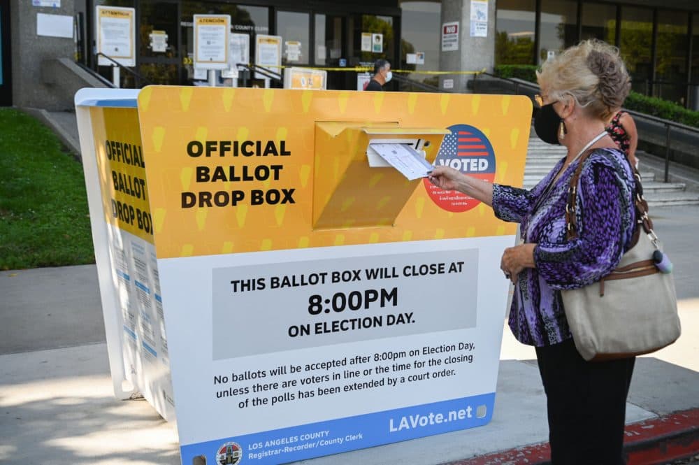 A woman drops off her California ballot into a ballot box outside the Los Angeles County Registrar-Recorder/County Clerk office, Aug. 27, 2021 in Norwalk, California. (Robyn Beck/AFP via Getty Images)