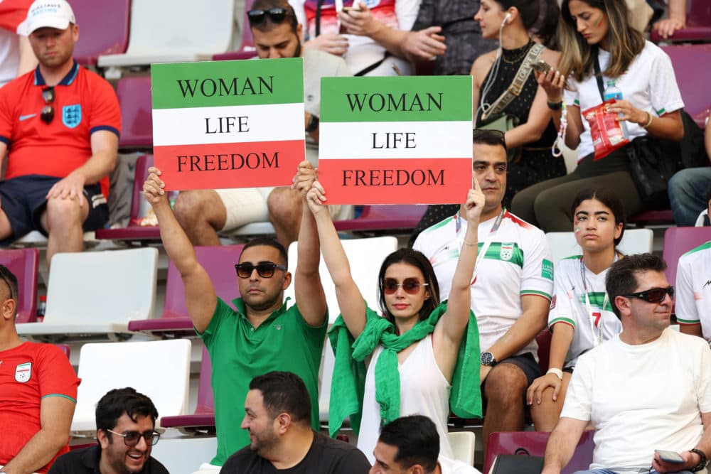 Iranian fans hold up signs advocating for women's rights prior to the FIFA World Cup Qatar 2022 Group B match between England and IR Iran at Khalifa International Stadium on Nov. 21, 2022 in Doha, Qatar. (Clive Brunskill/Getty Images)
