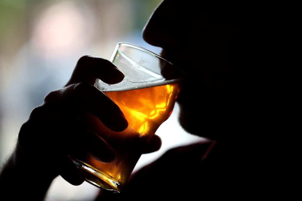 A man takes a sip of beer. (Justin Sullivan/Getty Images)