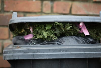 Christmas decorations sit on top of rubbish in a bin waiting to be collected outside a home. (Matt Cardy/Getty Images)