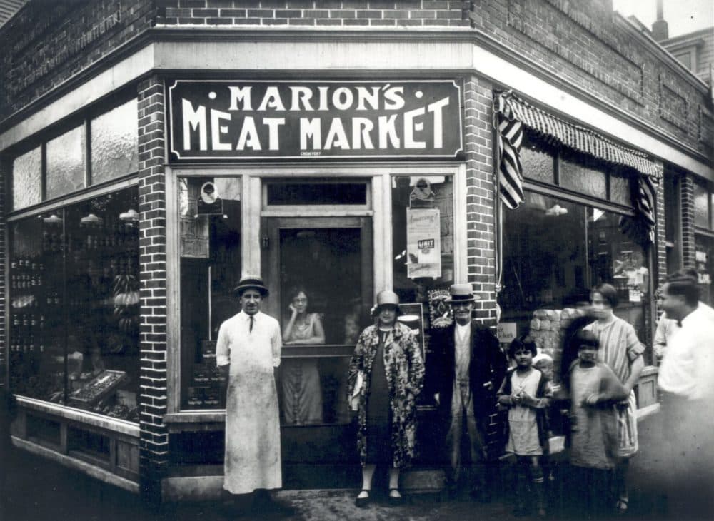 Marion's Meat Market, circa 1926, in the Little Canada neighborhood of Lowell. The man on the far left with long white apron, skinny tie, and straw hat is Paul Marion's grandfather, his pépère, Wilfrid Marion, owner of Marion's Meat Market. This store would later burn down as a result of an accidental fire. (Courtesy Paul Marion.) 