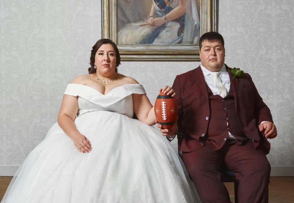 Newlyweds Michelle and Barry de Boer sit for a wedding portrait in the Queens Room of the Fletcher Hotel in Leeuwarden, Netherlands, on Aug. 28, 2021. Michelle, 33, a center for the Amsterdam Cats, and Barry, her offensive line coach, met on the field in 2017 and have been together since April 2018. (Julia Gunther)