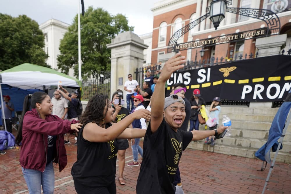 Gerber Piedrasanta, of Boston, front, joins with others dancing and chanting slogans during a rally in front of the State House in Boston on June 9 held in support of allowing immigrants in the country illegally to obtain driver's licenses in Massachusetts. (Steven Senne/AP)