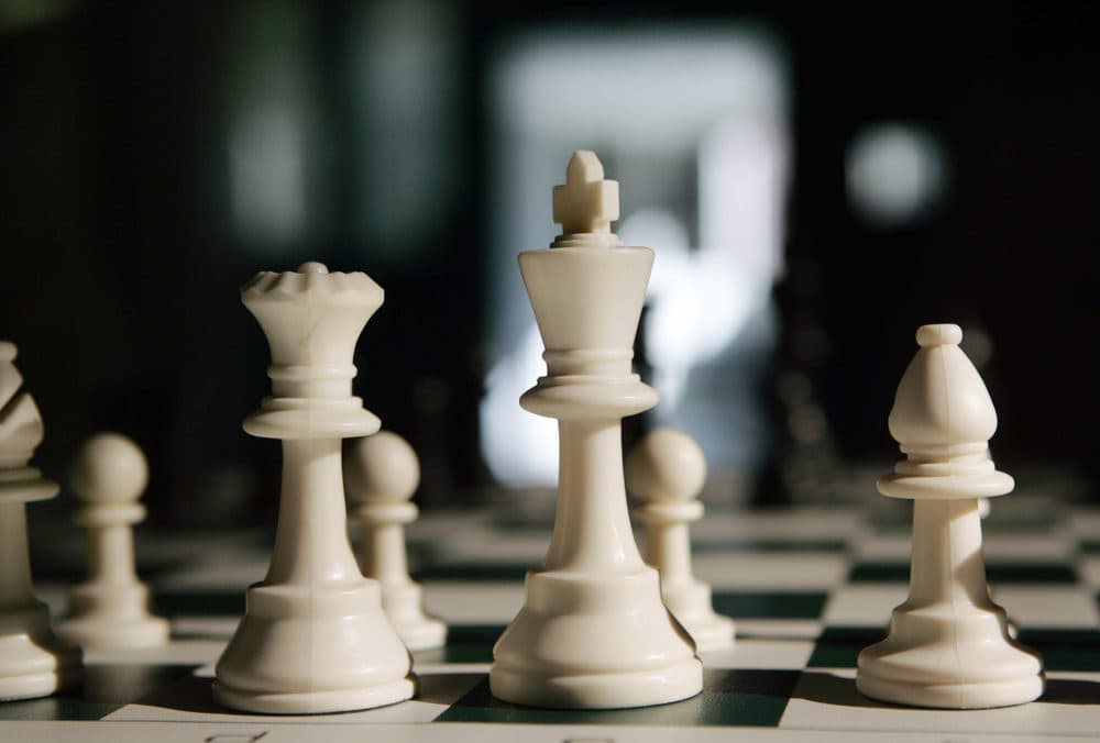 Chess pieces sit on a board. (Mel Evans/AP)