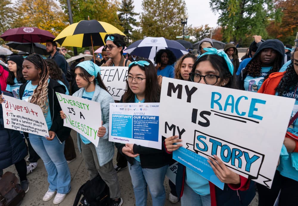Harvard student, Samaga Pokharel, right, and other activists rally as the Supreme Court hears oral arguments on a pair of cases that could decide the future of affirmative action in college admissions. (J. Scott Applewhite/AP)
