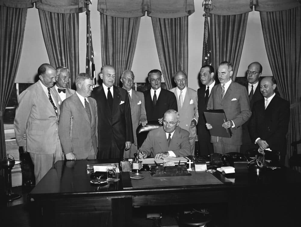 President Harry S. Truman signs a proclamation declaring into effect the 12-nation Atlantic Pact binding North America and Western Europe in a common defense alliance. (Byron Rollins/AP)