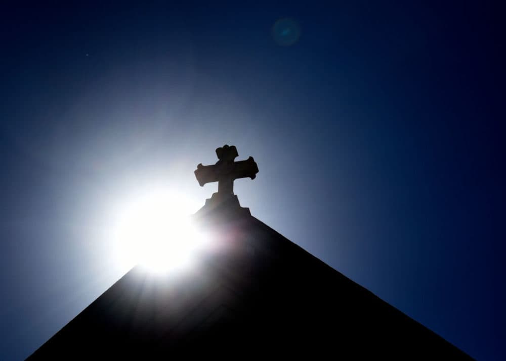 SANTA FE, NEW MEXICO - JUNE 21, 2020:  The sun rises behind a stone cross atop the historic Cathedral Basilica of St. Frances of Assisi in Santa Fe, New Mexico. (Photo by Robert Alexander/Getty Images)