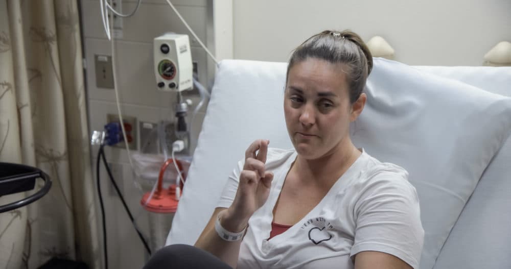 ViaCyte trial participant Maren Badger crossing her fingers in a hospital bed. (Courtesy of Abramorama)