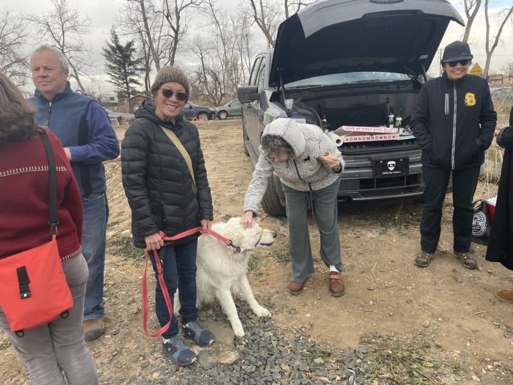 Mary Hagler, with her dog Poppy, having a groundbreaking with her friends and neighbors next to where her home burned down during the Marshall Fire last year in Superior, Colorado. (Courtesy of Miguel Otárola)