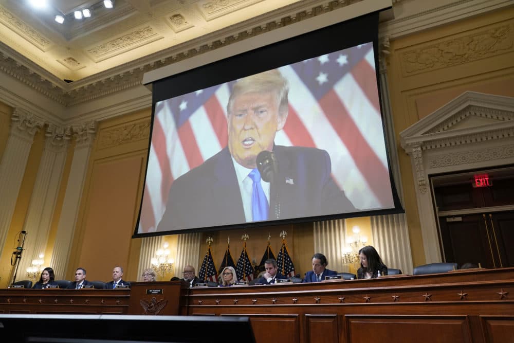 A video of former President Donald Trump is shown on a screen, as the House select committee investigating the Jan. 6 attack on the U.S. Capitol holds its final meeting on Capitol Hill on Dec. 19. (J. Scott Applewhite/AP)