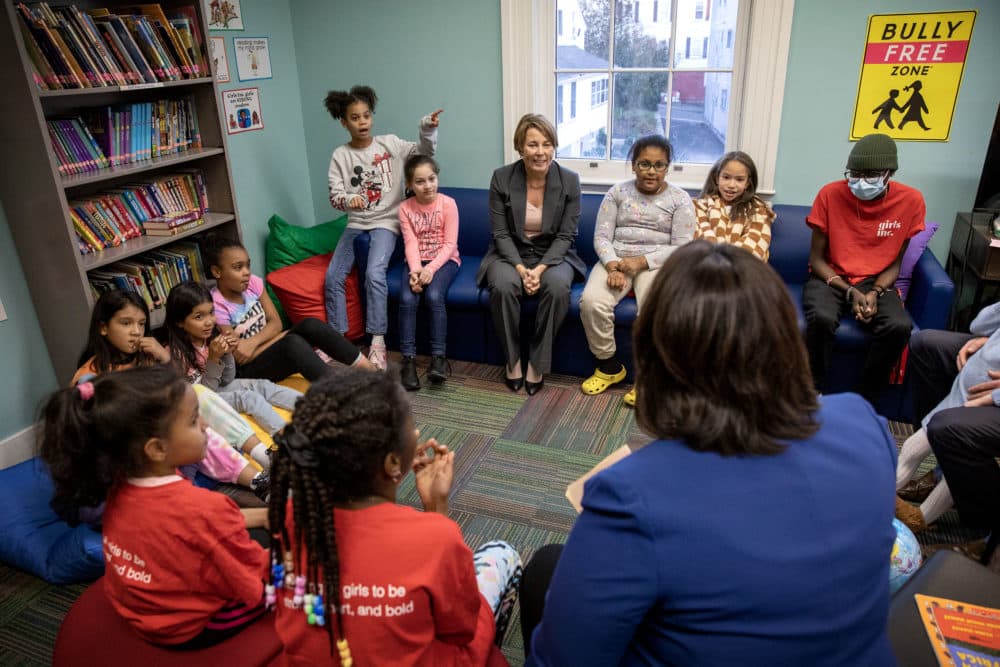 Maura Healey and Kim Driscoll talk with a group of elementary school students at Girls Inc. of Lynn. (Robin Lubbock/WBUR)