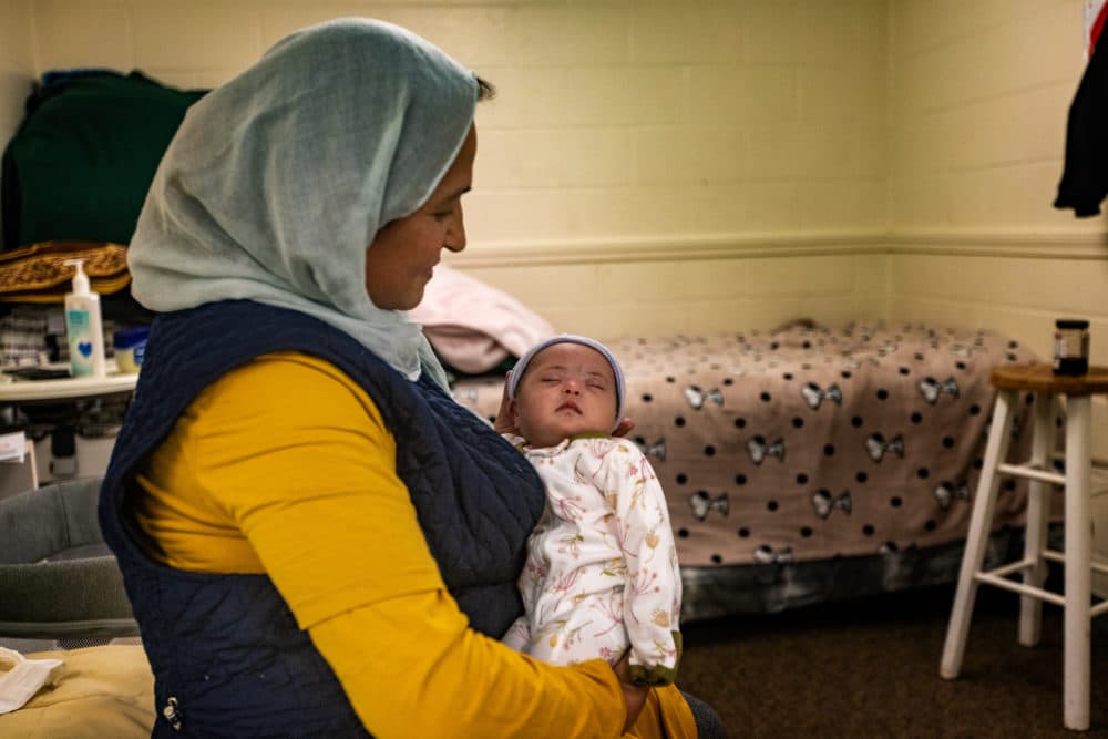 Gulalai holds her infant Nadya, her ninth child and the first U.S. citizen in the family. (Jesse Costa/WBUR)
