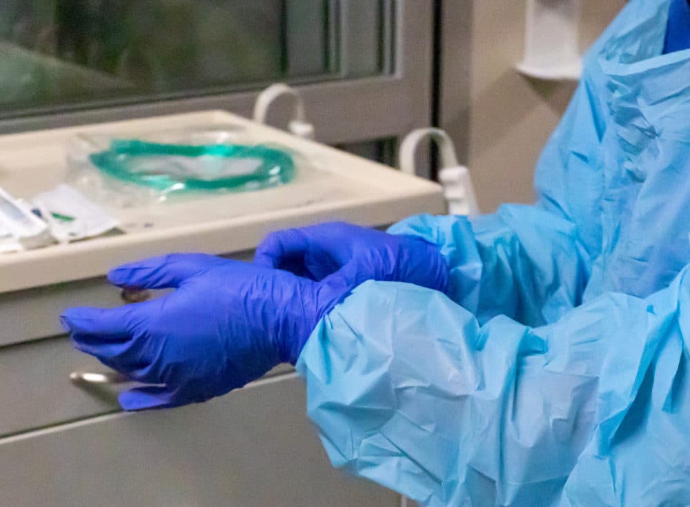A nurse adjusts her gloves. (Mike Zacchino/KDRV via AP)