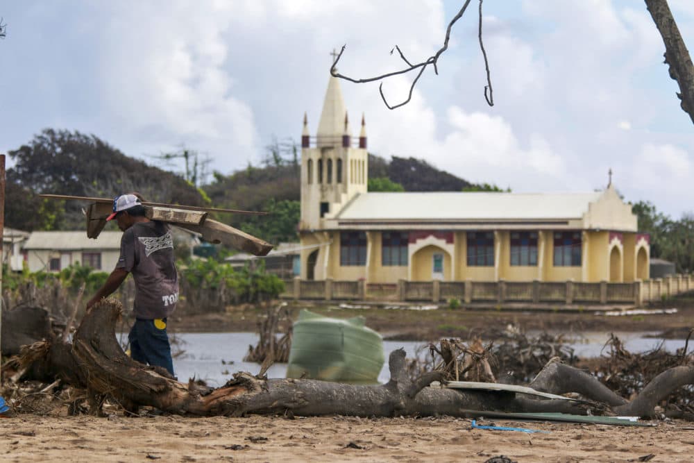 A local man clears debris on Nomuka Island in Tonga. (LSCSO Rye Huckel/AP)