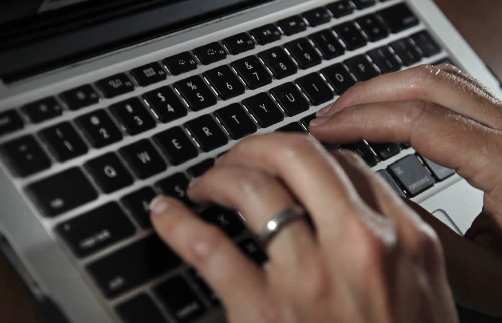 A person types on a laptop keyboard. (Elise Amendola/AP)