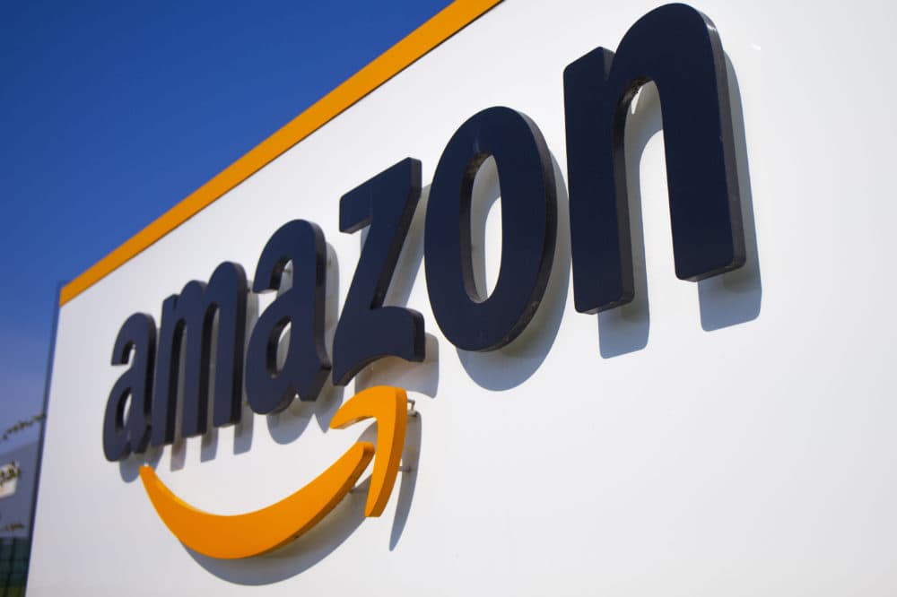A company logo is seen at the entrance of Amazon. (Michel Spingler/AP)