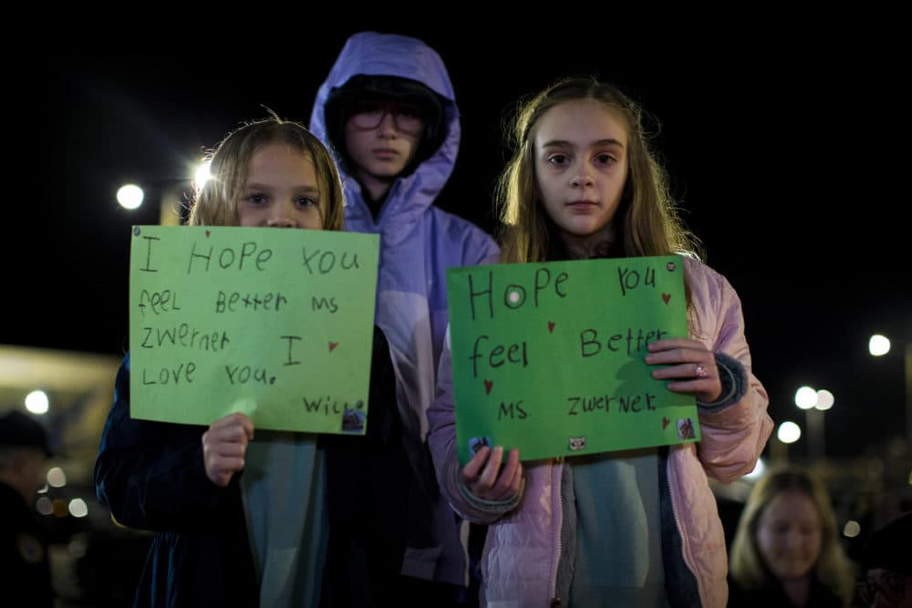 Willow Crawford, left, and her older sister Ava, right, join friend Kaylynn Vestre, center, in expressing their support for Richneck Elementary School first-grade teacher Abby Zwerner during a candlelight vigil in her honor in Newport News, Va., Monday, Jan. 9, 2023. Zwerner was shot and wounded by a 6-year-old student while teaching class on Friday, Jan. 6. (John C. Clark/AP)
