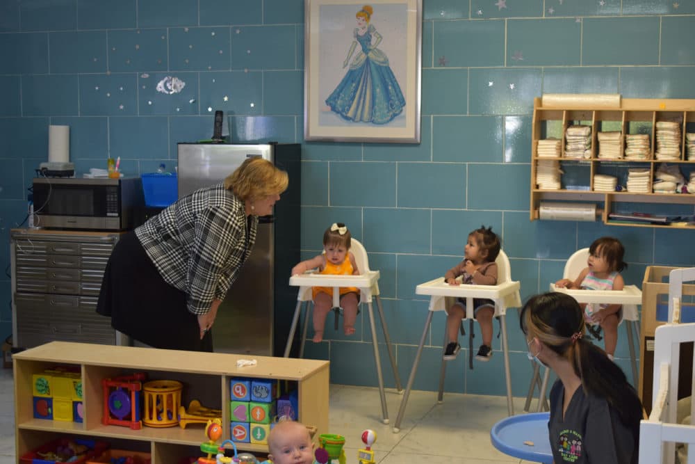 Elizabeth Groginsky, cabinet secretary for early childhood education and care in New Mexico, left, visits with infants during a months long listening tour in 2022. (Courtesy of New Mexico Early Childhood Education and Care Department)