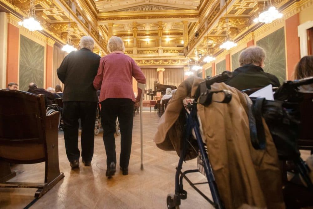 Elderly spectators needing a walking aid arrive to attend a concert specifically tailored to people living with dementia at the Wiener Musikverein in Vienna on December 5, 2022. (ALEX HALADA/AFP via Getty Images)