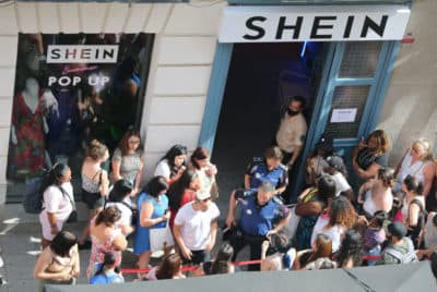 Two Municipal Police officers coordinate the queue of people to enter the first physical SHEIN store in Madrid, on 02 June, 2022 in Madrid, Spain. Chinese 'online' fashion brand Shein opens its first 'pop up store' in Madrid after the good reception it has had recent similar openings in countries such as France, Mexico and the United States. The store opens its doors today and will be open until June 5, where customers will be able to shop for women's and men's fashion collections. (Photo By Cezaro De Luca/Europa Press via Getty Images)