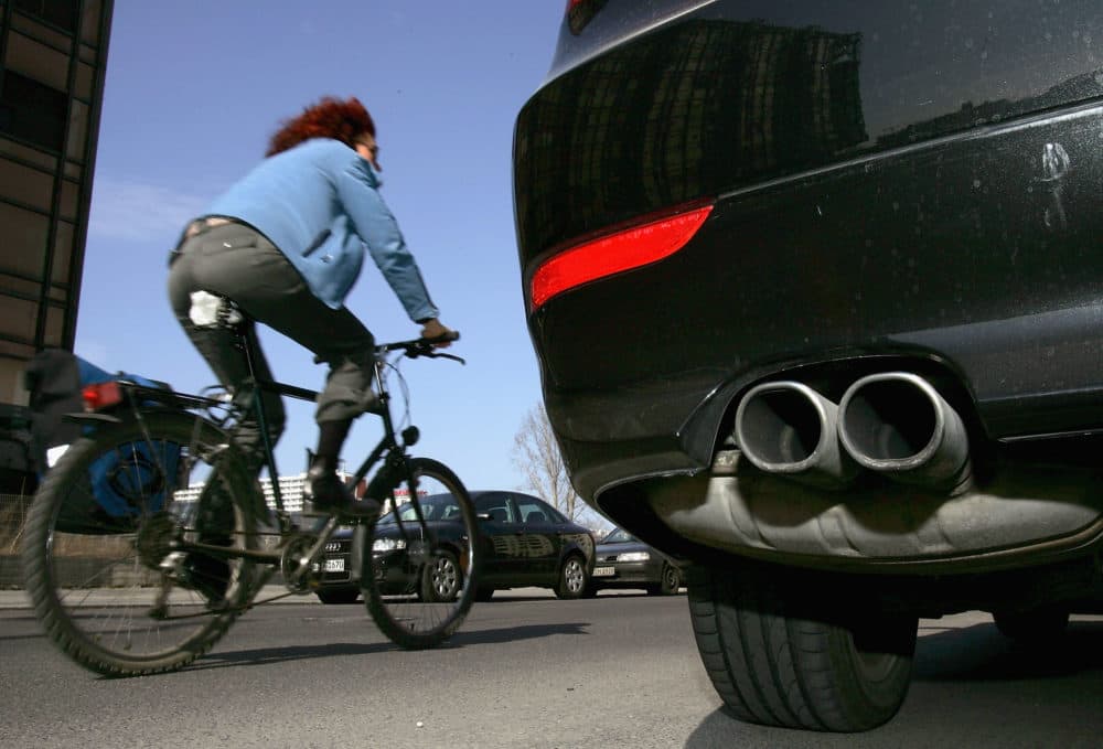 A cyclist drives past a parked car. (Sean Gallup/Getty Images)